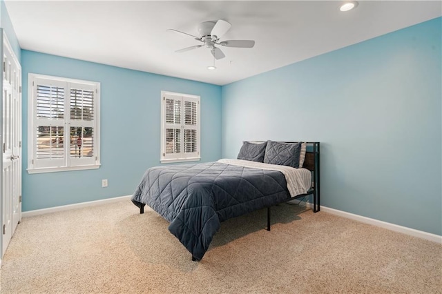 carpeted bedroom featuring recessed lighting, baseboards, and a ceiling fan