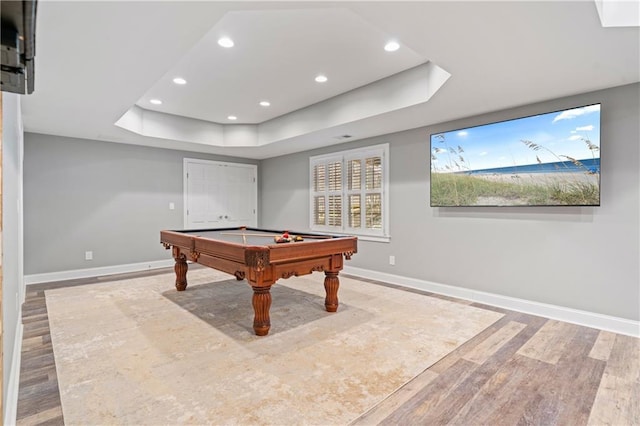 game room featuring baseboards, recessed lighting, a raised ceiling, wood finished floors, and billiards