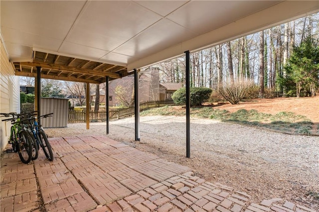 view of patio / terrace with a storage shed, an outdoor structure, and fence