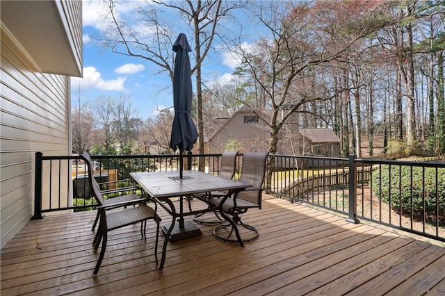 wooden terrace with outdoor dining space