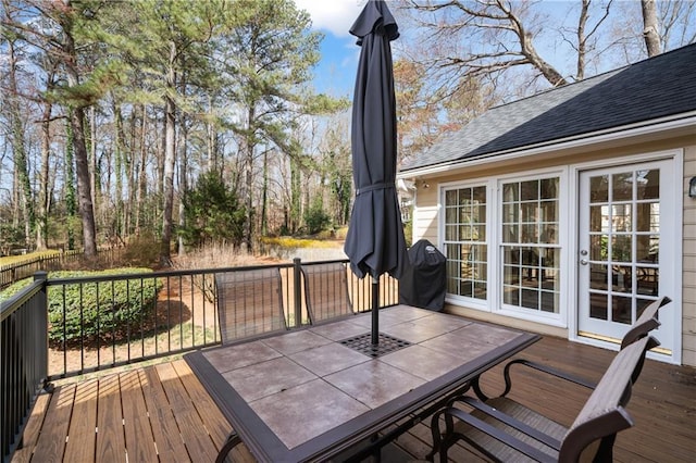 wooden deck with area for grilling and outdoor dining area