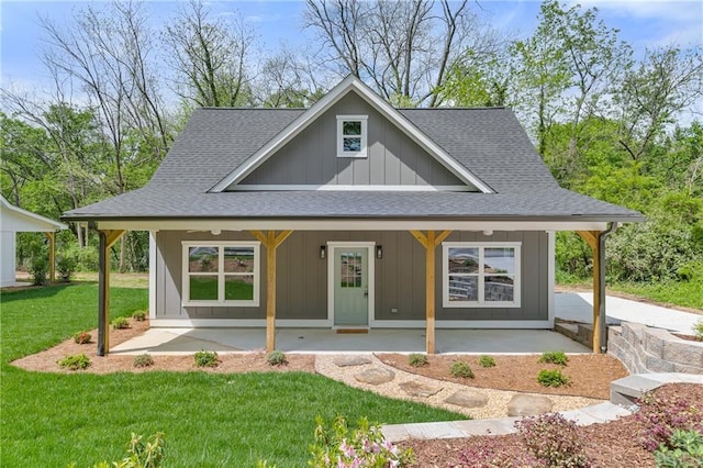 5232 W Mountain St, Stone Mountain, GA 30083 - view of front of property with roof with shingles, a porch, board and batten siding, and a front yard