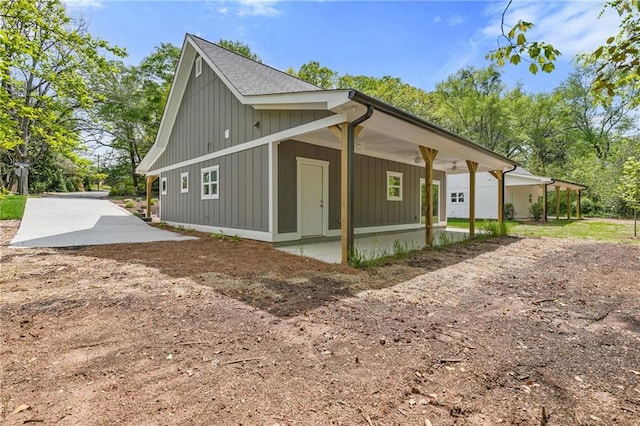 5232 W Mountain St, Stone Mountain, GA 30083 - view of property exterior featuring board and batten siding and a patio