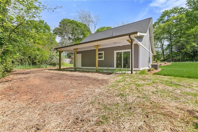 5232 W Mountain St, Stone Mountain, GA 30083 - rear view of property featuring a shingled roof and a lawn