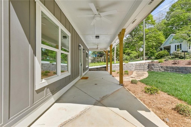 5232 W Mountain St, Stone Mountain, GA 30083 - covered porch with a ceiling fan and a yard