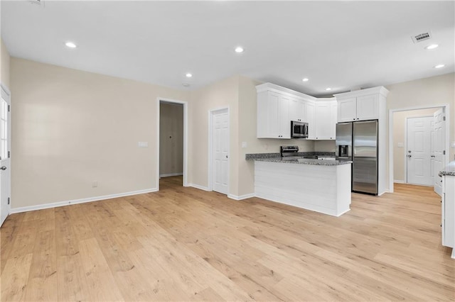 5232 W Mountain St, Stone Mountain, GA 30083 - kitchen with appliances with stainless steel finishes, white cabinetry, light wood-type flooring, a peninsula, and recessed lighting