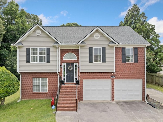 173 Cline Smith Rd NE, Cartersville, GA 30121 - split foyer home featuring concrete driveway, brick siding, a garage, and roof with shingles