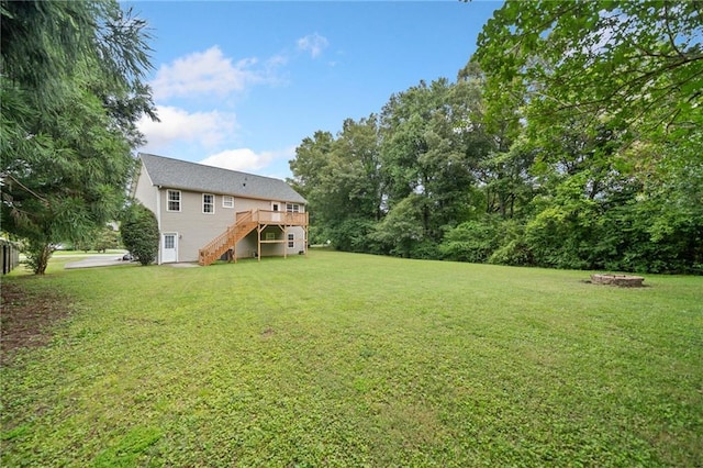 173 Cline Smith Rd NE, Cartersville, GA 30121 - view of green lawn with stairs, a deck, and an outdoor fire pit