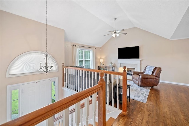 173 Cline Smith Rd NE, Cartersville, GA 30121 - hall with a chandelier, vaulted ceiling, wood finished floors, and an upstairs landing