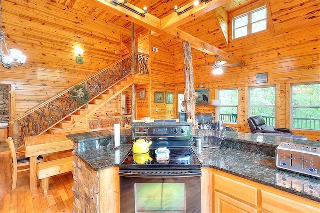 kitchen with wooden ceiling, wood-type flooring, wooden walls, black electric range oven, and open floor plan