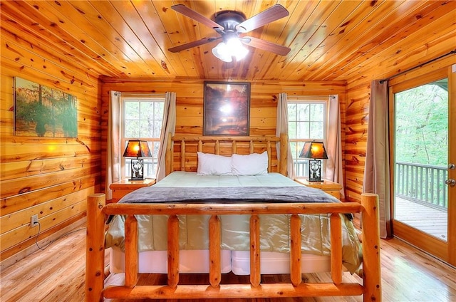 bedroom with light wood finished floors, wooden ceiling, access to outside, and multiple windows