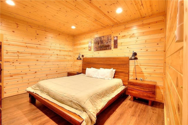 bedroom featuring wooden walls, light wood finished floors, recessed lighting, and wooden ceiling