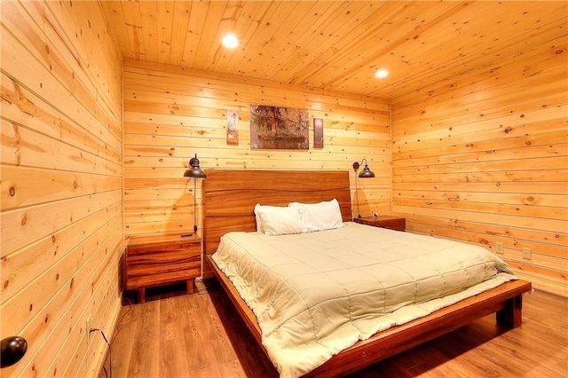 bedroom with wooden walls, recessed lighting, wooden ceiling, and wood finished floors