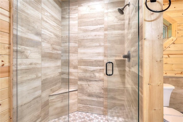 full bath with toilet and a shower stall