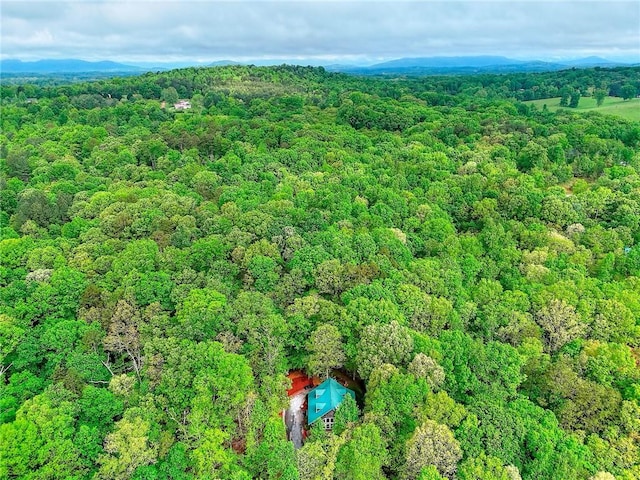 birds eye view of property with a view of trees