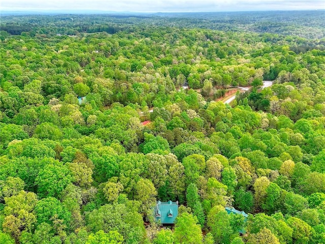 bird's eye view with a wooded view