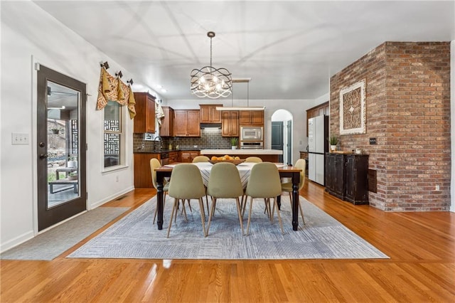 dining area featuring an inviting chandelier and light hardwood / wood-style flooring