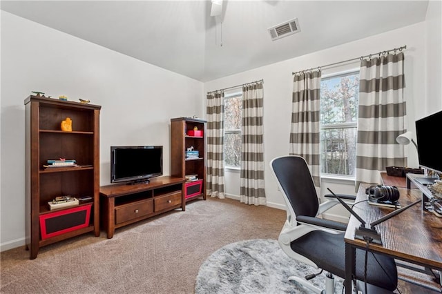 carpeted home office with lofted ceiling and ceiling fan