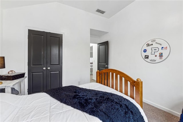 bedroom featuring carpet, lofted ceiling, and a closet