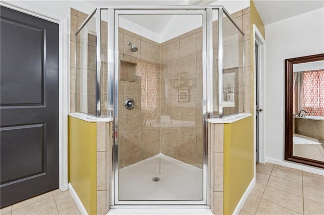 bathroom with walk in shower and tile patterned flooring