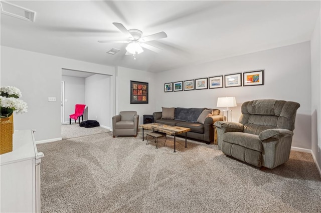 carpeted living room with ceiling fan