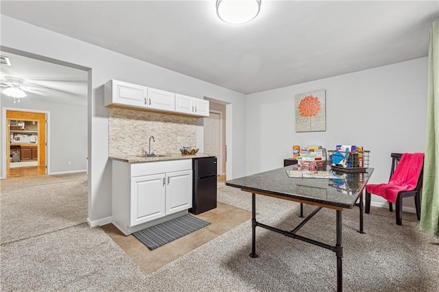 home office featuring light carpet and sink