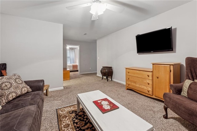 carpeted living room with ceiling fan