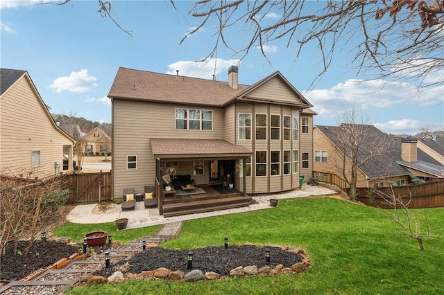 rear view of property featuring a yard, outdoor lounge area, and a patio