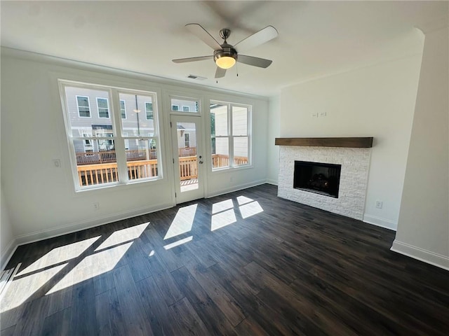 unfurnished living room with a fireplace, ceiling fan, and dark wood-type flooring