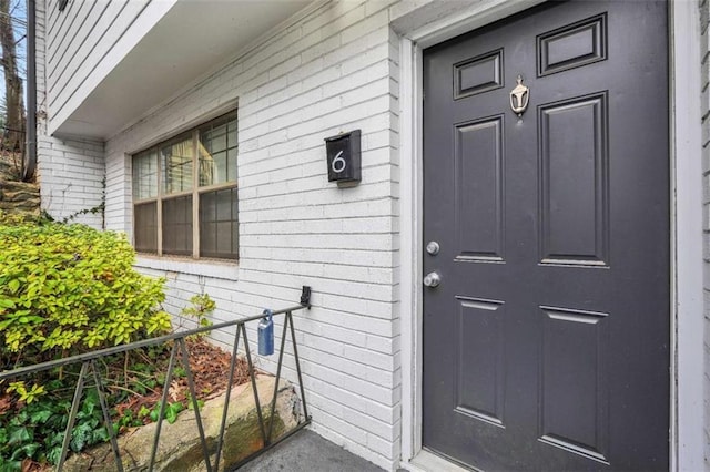 view of exterior entry with brick siding