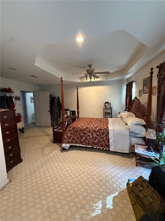 bedroom with ceiling fan, recessed lighting, and a raised ceiling