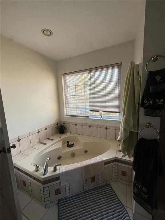 full bathroom with tile patterned flooring and a jetted tub