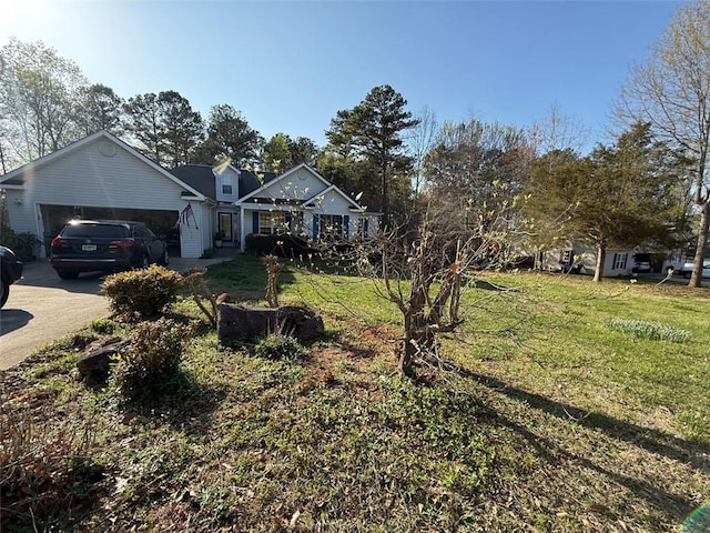 view of front of home featuring a garage, concrete driveway, and a front yard