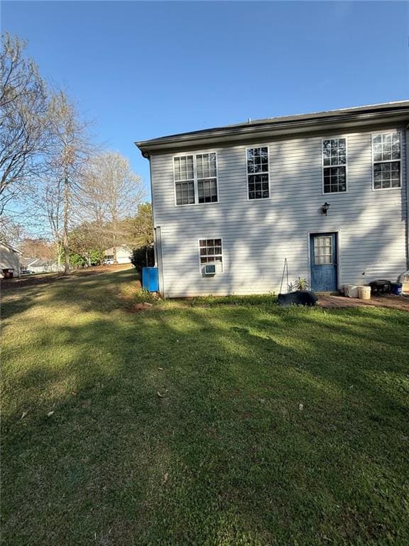 back of property featuring a yard