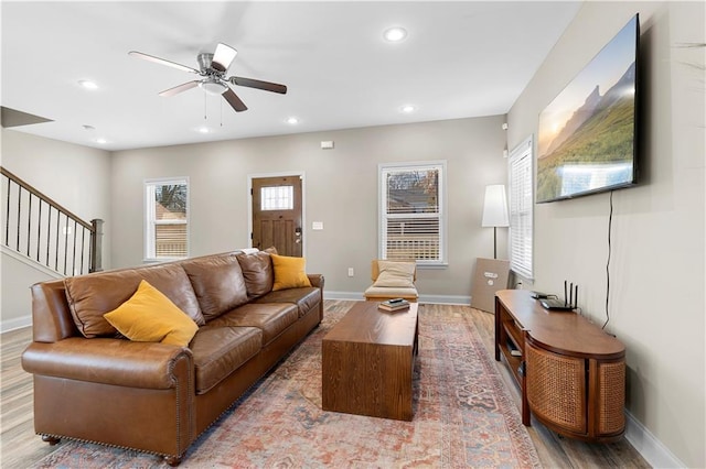 living room with hardwood / wood-style flooring and ceiling fan