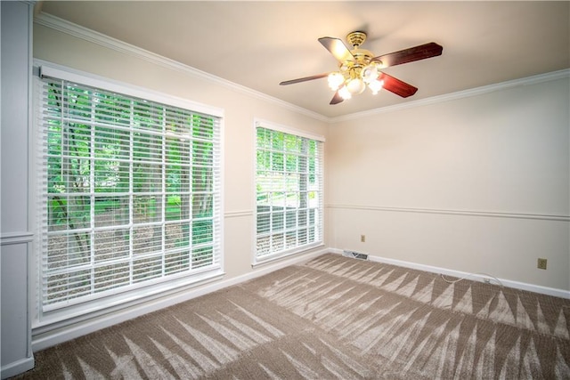 carpeted empty room with ceiling fan and crown molding