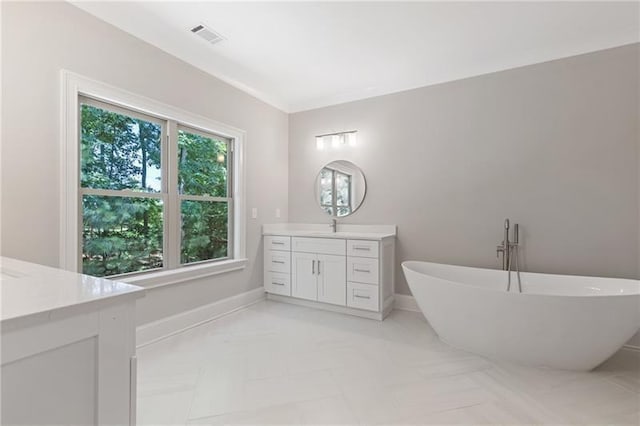 bathroom with vanity and a bath