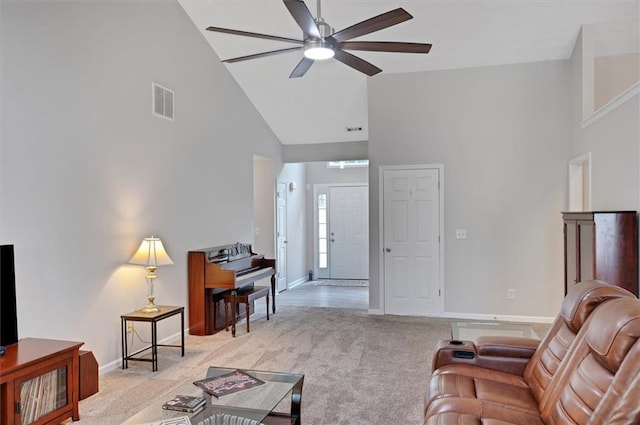living area featuring a ceiling fan, visible vents, light colored carpet, high vaulted ceiling, and baseboards