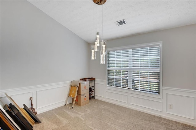 dining area featuring a wainscoted wall, a wealth of natural light, carpet flooring, and visible vents