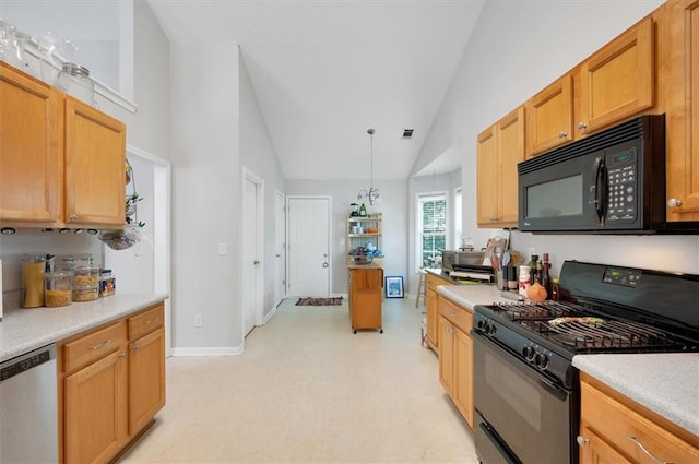 kitchen featuring light countertops, baseboards, lofted ceiling, and black appliances