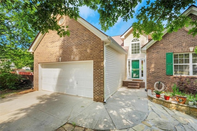 view of front of house featuring concrete driveway, brick siding, and a garage