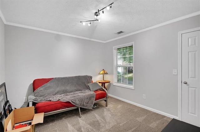 sitting room with crown molding, carpet flooring, a textured ceiling, and visible vents