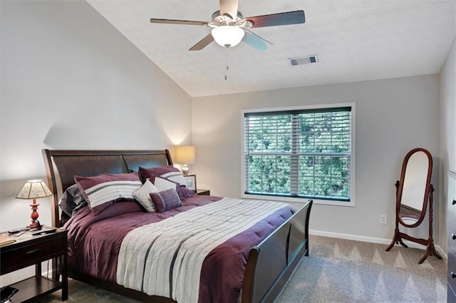 bedroom with carpet floors, a textured ceiling, baseboards, lofted ceiling, and visible vents