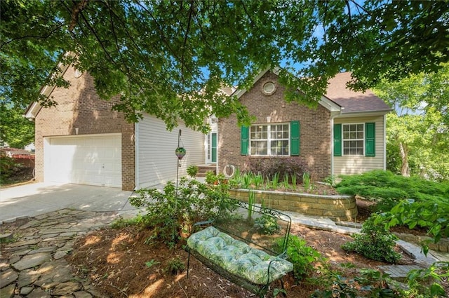 view of front of home featuring brick siding, an attached garage, and driveway