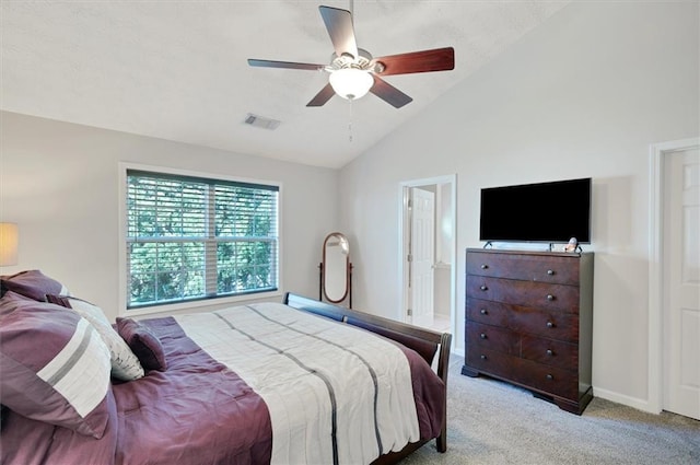 carpeted bedroom featuring visible vents, a ceiling fan, and vaulted ceiling