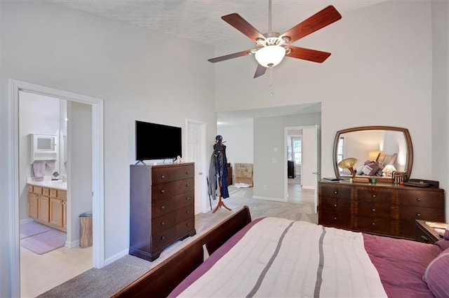 bedroom featuring baseboards, light carpet, and high vaulted ceiling