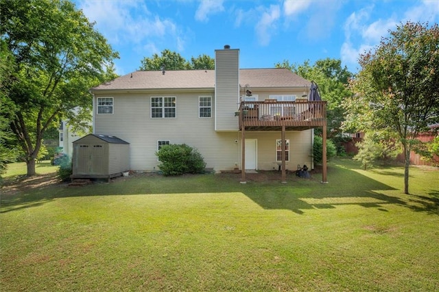 back of house featuring an outdoor structure, a wooden deck, a chimney, a storage unit, and a lawn
