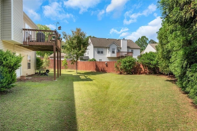 view of yard featuring fence and a deck