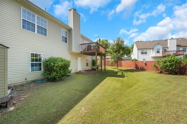 view of yard featuring fence and a deck