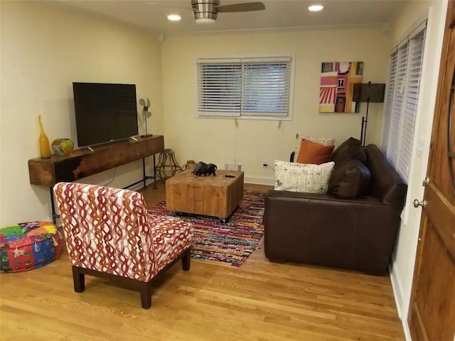 living room with light wood-type flooring and ceiling fan